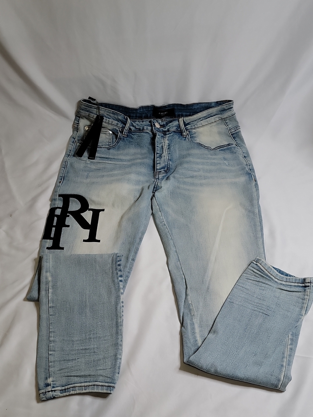 AMIRI Light Blue Slim Straight Jeans with Black Patch Logo
